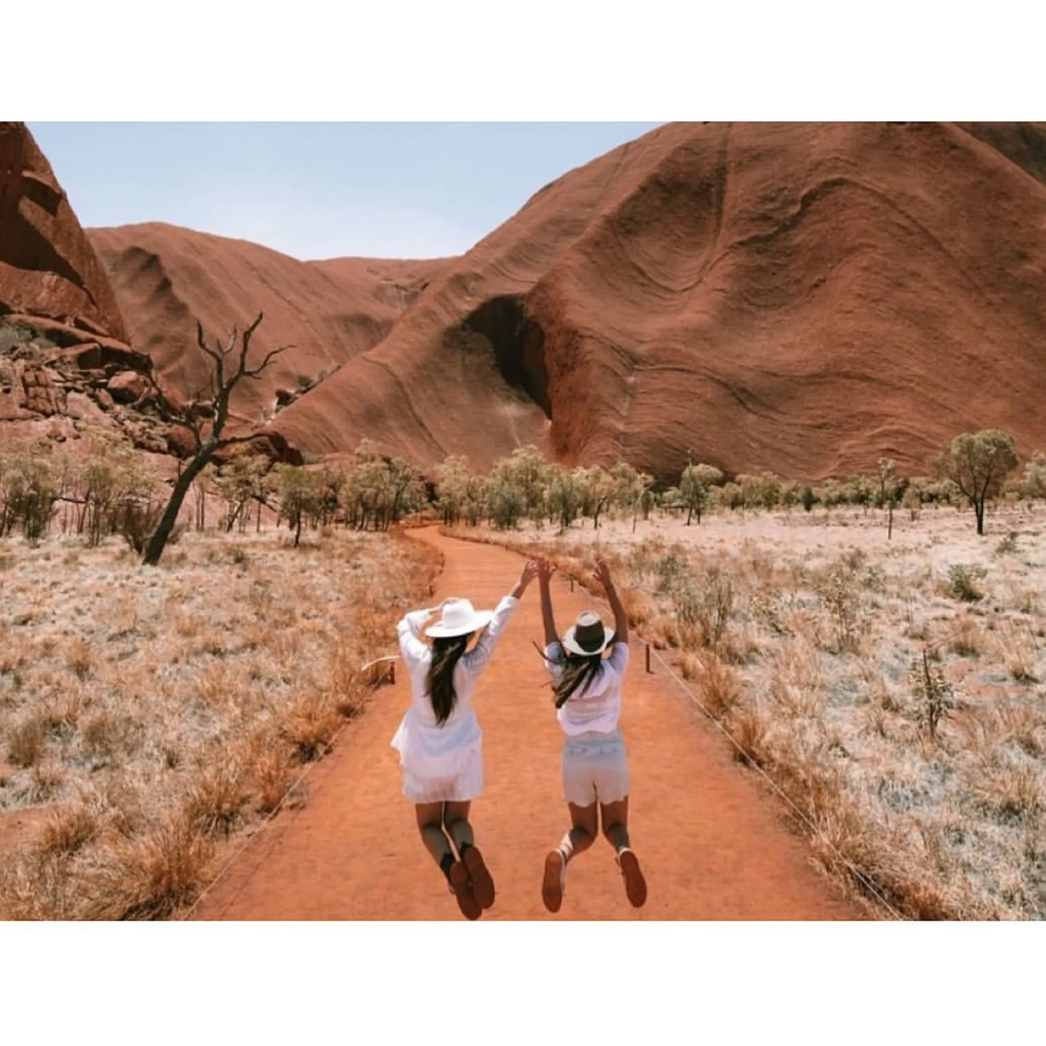 uluru and visitors in the outback